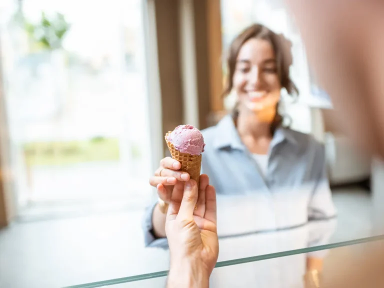 A woman buys ice cream.