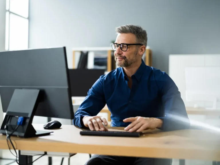 A man does accounting in his office.