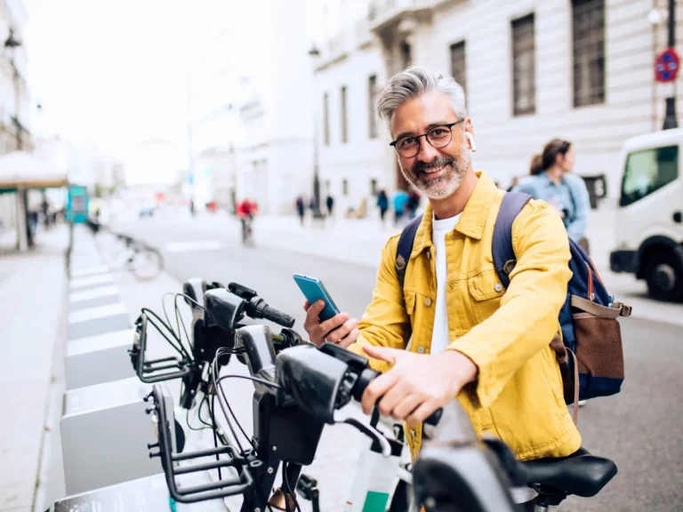 A man is taking part in the usership economy by using a shared bike