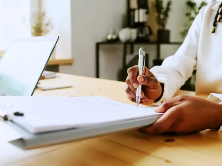 A woman is signing an agreement.