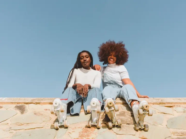 Two women on roller skates.