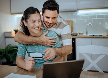 A happy couple buying something online