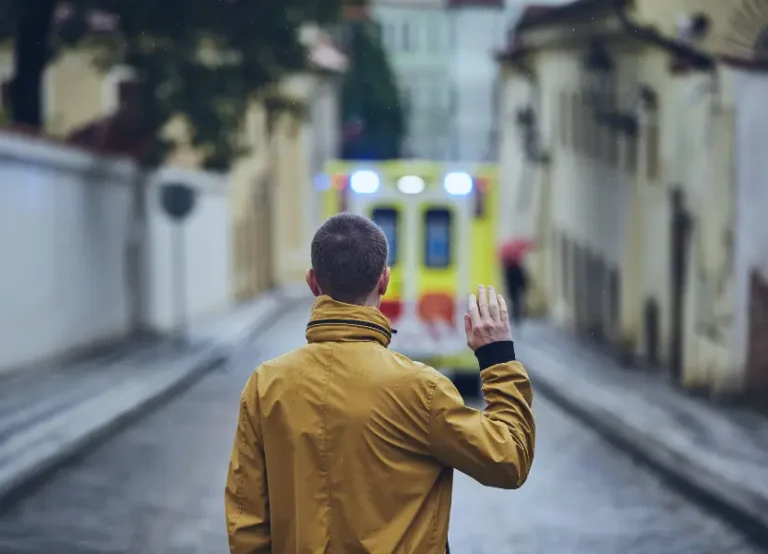A man waving goodbye, his back turned to the viewer