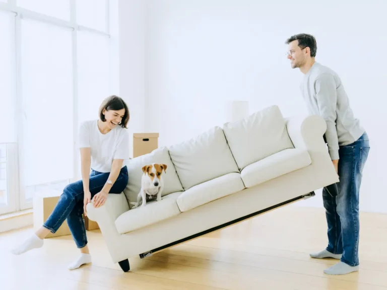 A happy couple and their dog is moving in.