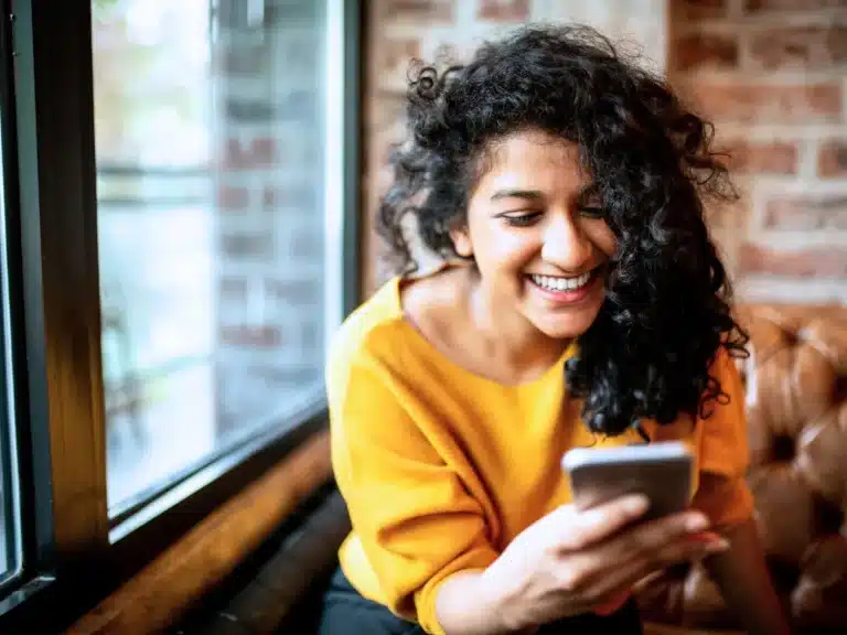 A woman is online shopping on her smartphone.