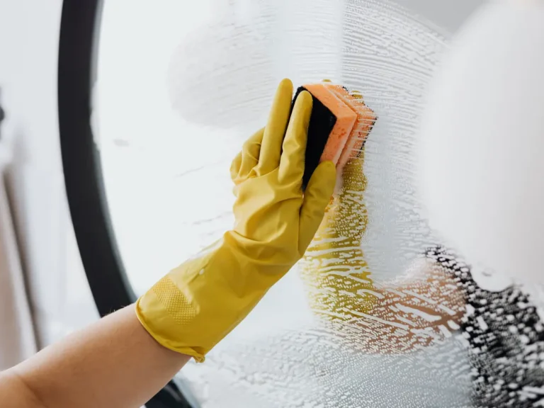A person cleaning a mirror