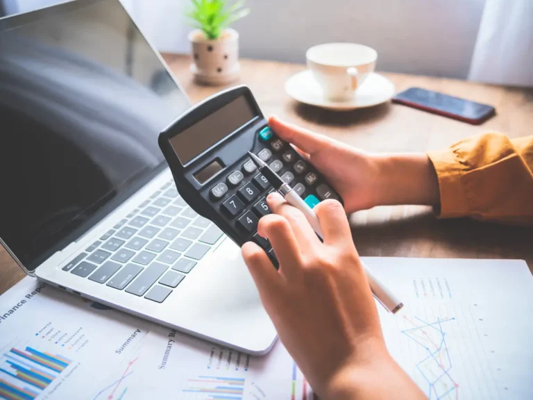 A person is calculating the costs of something.