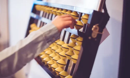 A kid is using an abacus