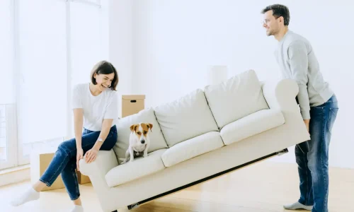 A happy couple and their dog is moving in.