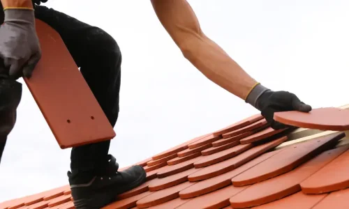 A person renovates a roof.