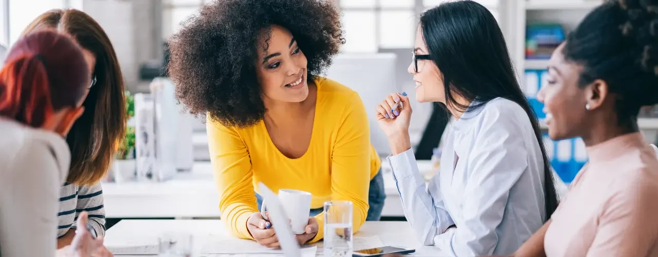 A group of young professionals brainstorm at a table.
