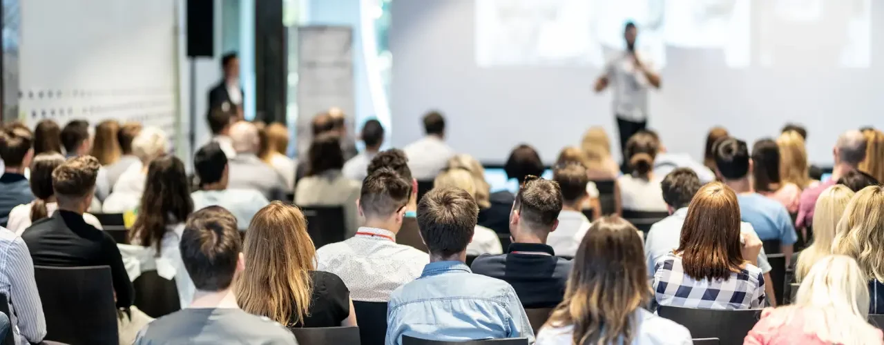 An audience is listening to a speaker.
